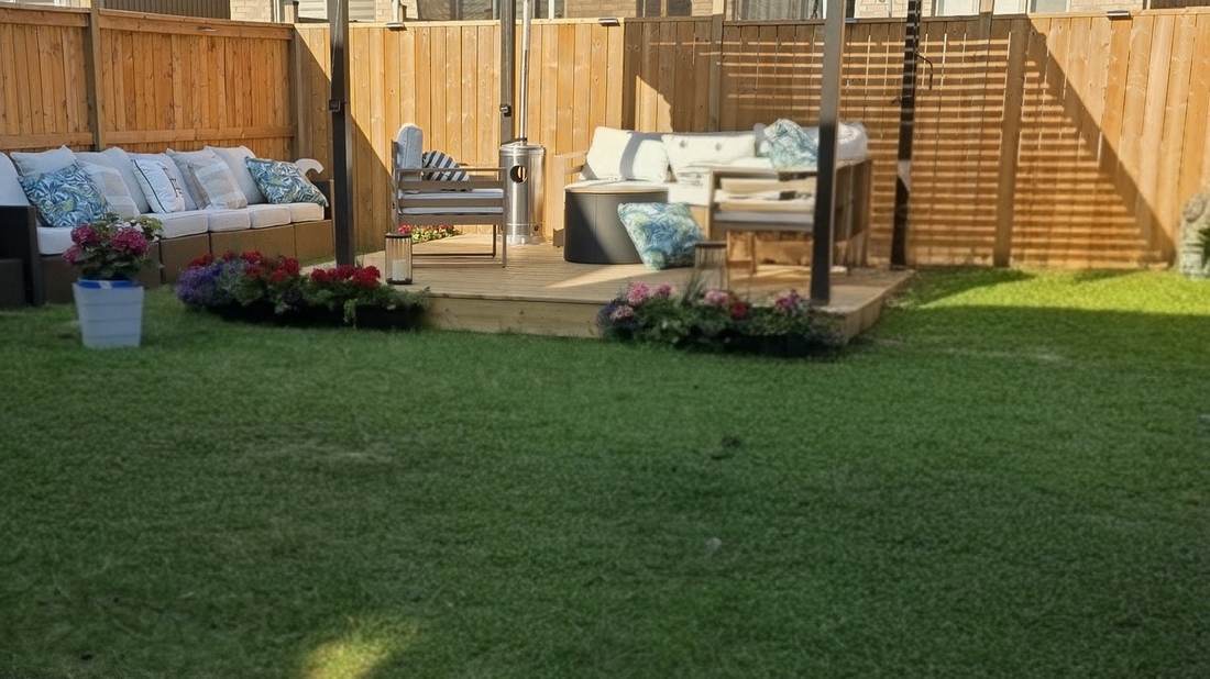 Fenced Collingwood back yard with a freshly cut lawn and a covered patio